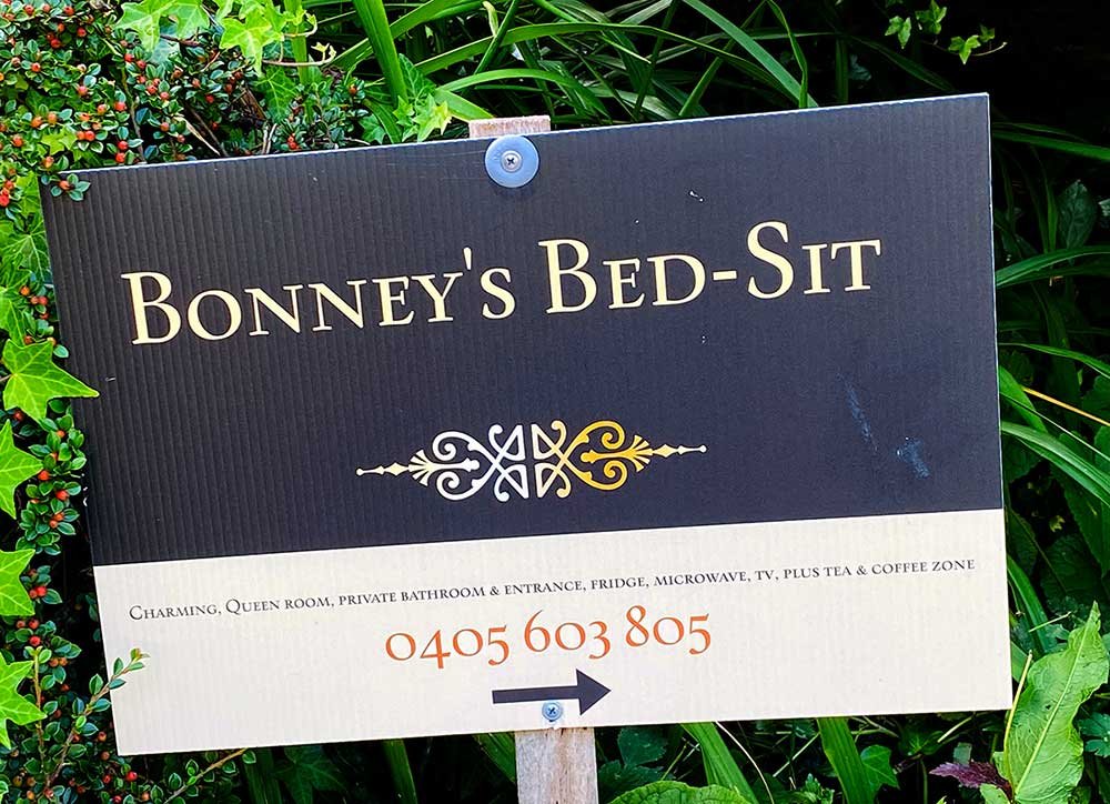 The outdoor sign guiding you to the Bonney's Bedsit door