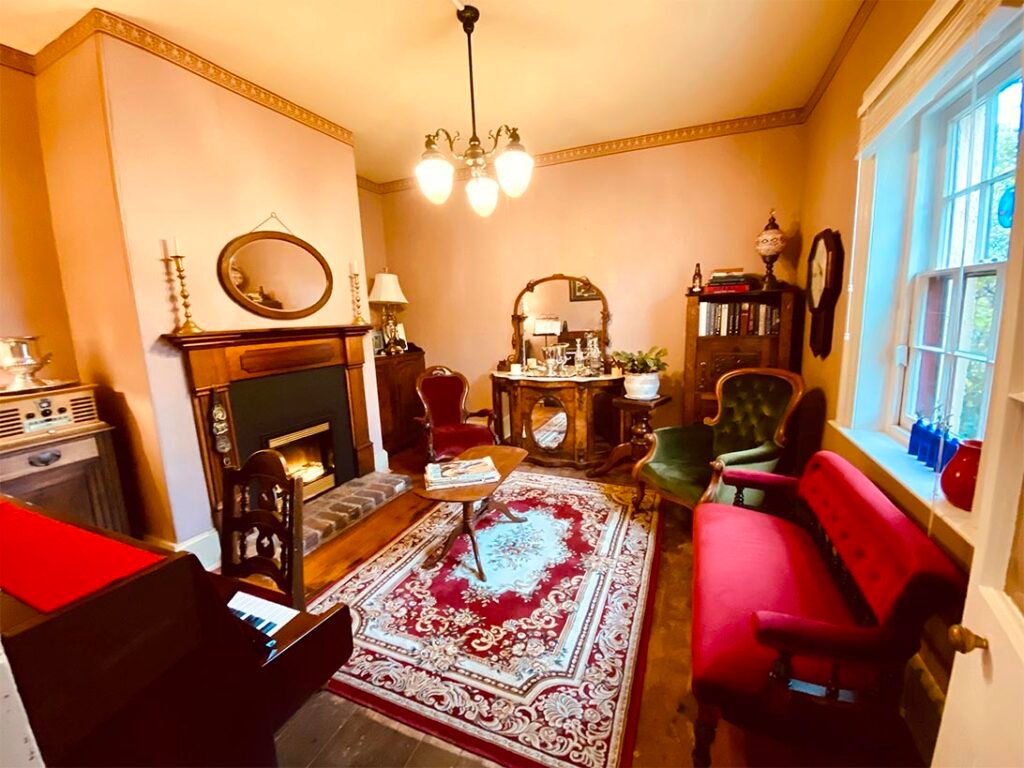 The guest lounge with piano and fireplace