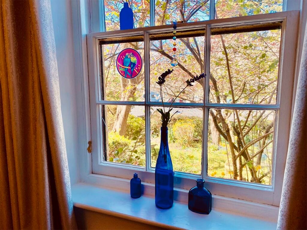 Decorative blue vases in front of an original sash window at Bonney's Inn